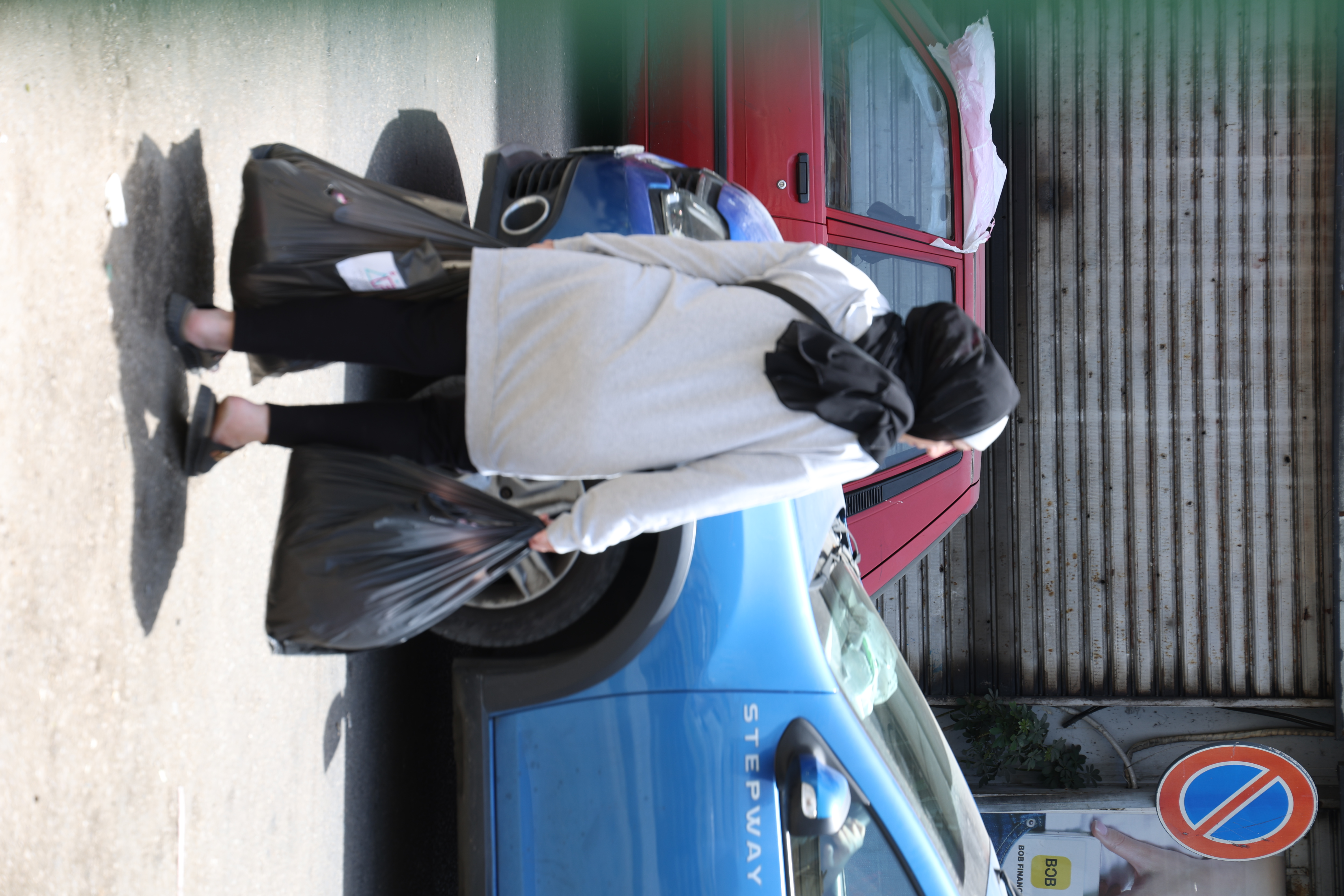 Lebanese woman carrying aid bags in the street